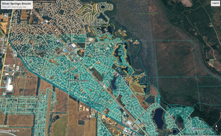 Aerial satellite view of Silver Springs Shores showing a dense residential neighborhood with streets, houses, lots, and adjacent wetlands and water.